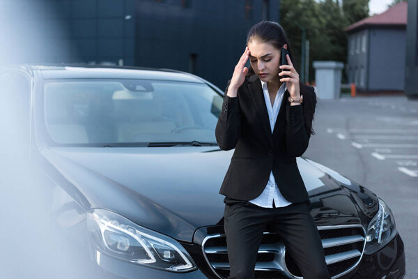 Troubled businesswoman talking on phone
