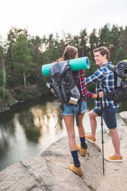 couple with backpacks having hiking trip clipart