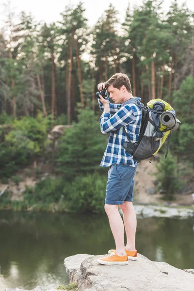 Hiker taking photo of lake — Free Stock Photo