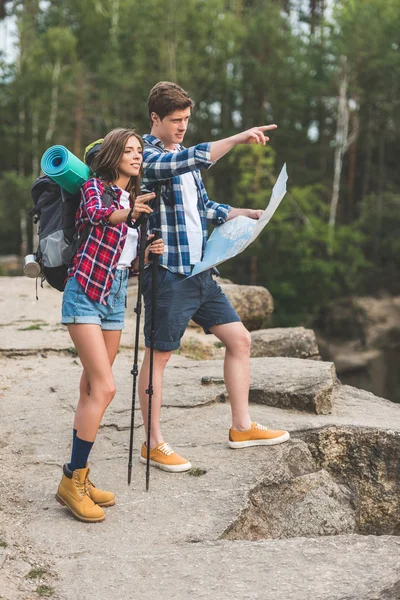 Couple of hikers with map — Stock Photo, Image