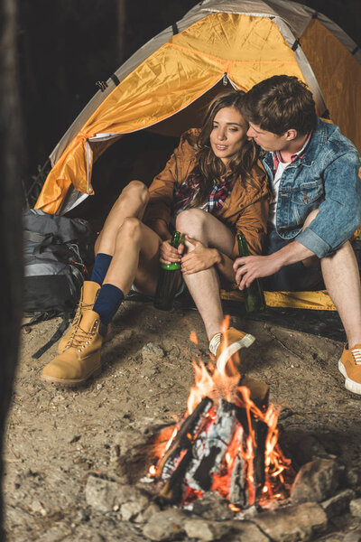 couple on hiking trip drinking beer