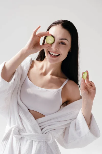 Woman holding slices of cucumber — Stock Photo, Image