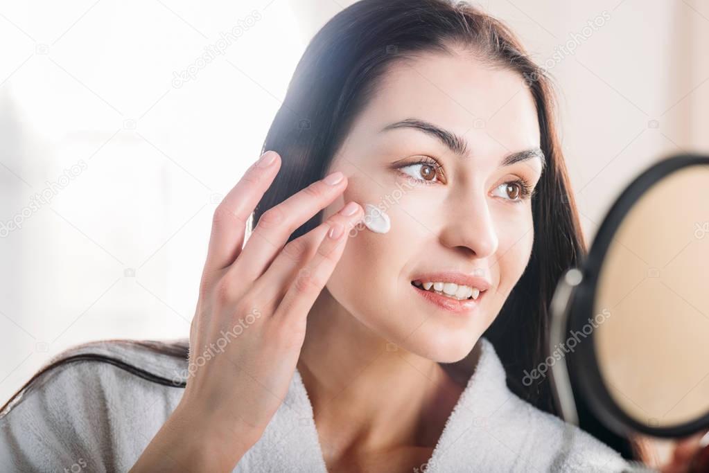 Woman applying face cream