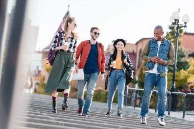 multicultural friends walking on street clipart