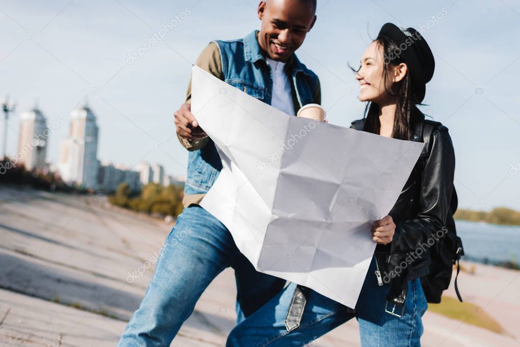 multicultural couple with map