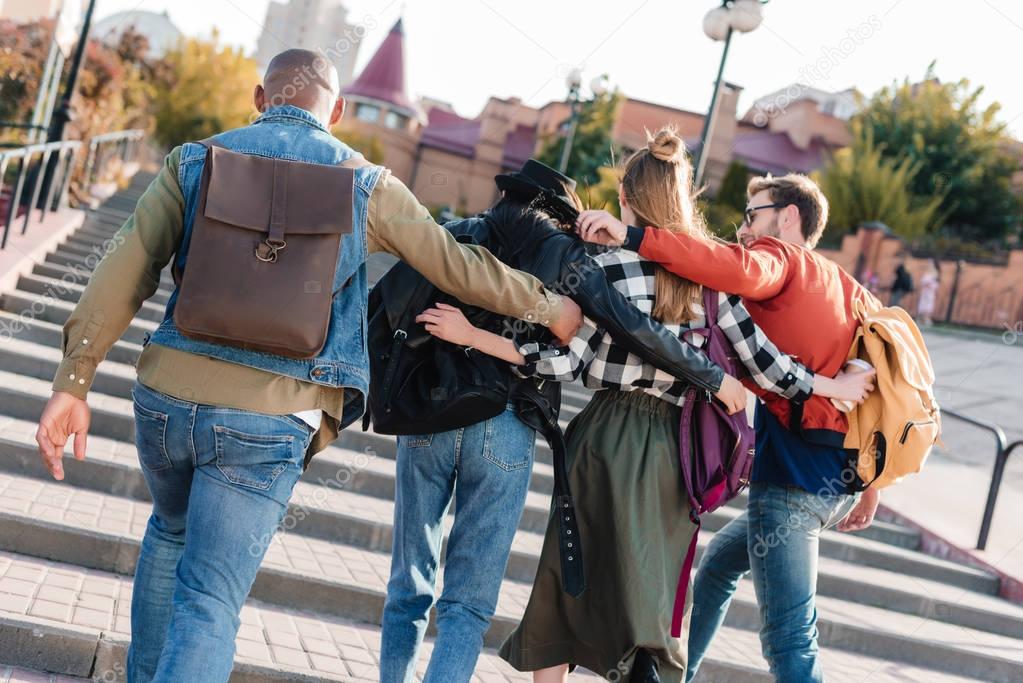 multicultural friends walking on street