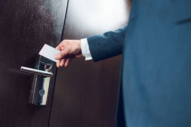 businessman opening hotel room door clipart