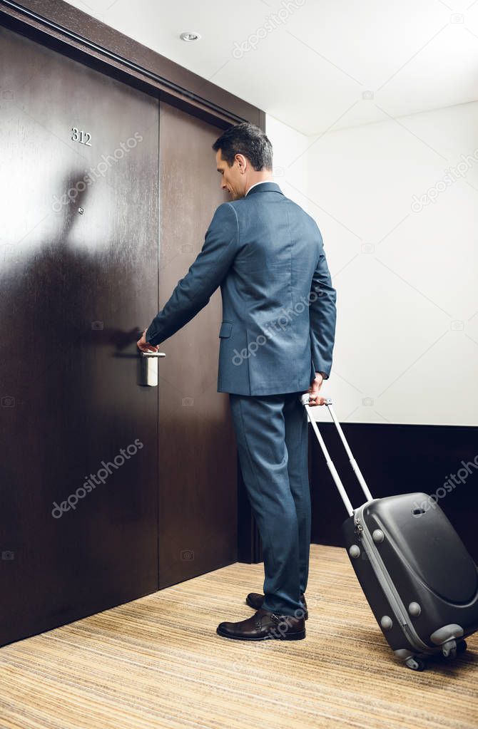 Businessman opening hotel door