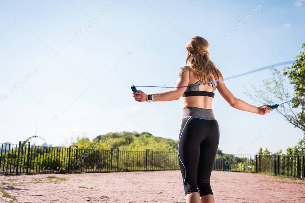 sportswoman jumping on skipping rope