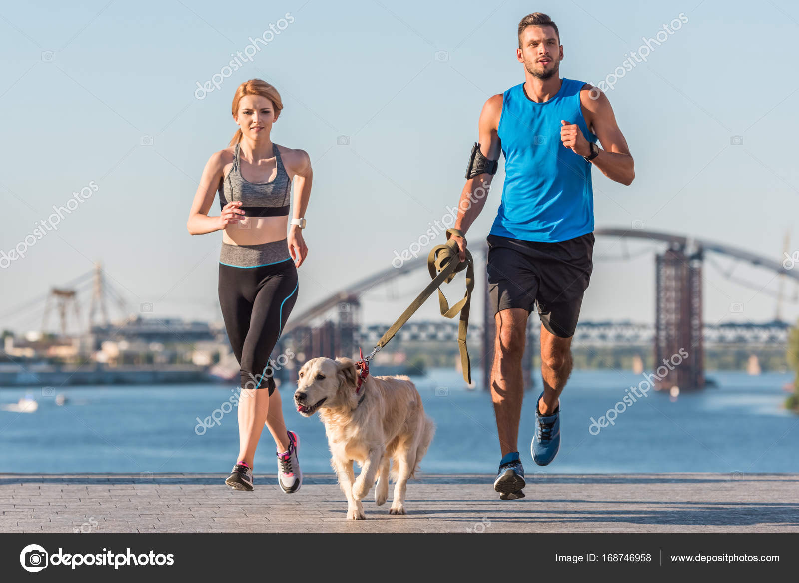 Sports couple jogging with dog — Stock Photo © ArturVerkhovetskiy
