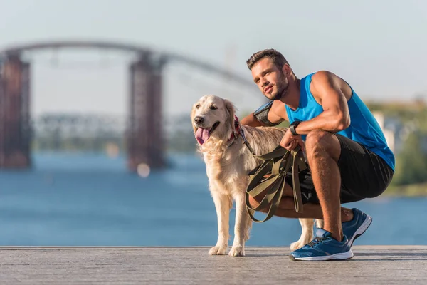 Sportswoman with dog on quay — Stock Photo, Image