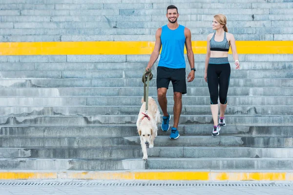 Deportes pareja caminar con perro — Foto de Stock