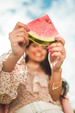girl holding slice of watermelon clipart