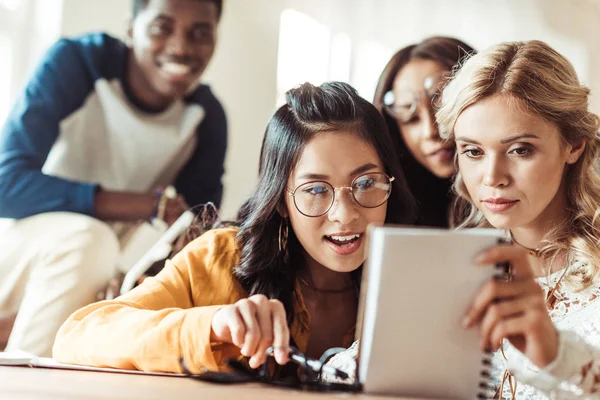 Excited students looking at notebook — Stock Photo, Image