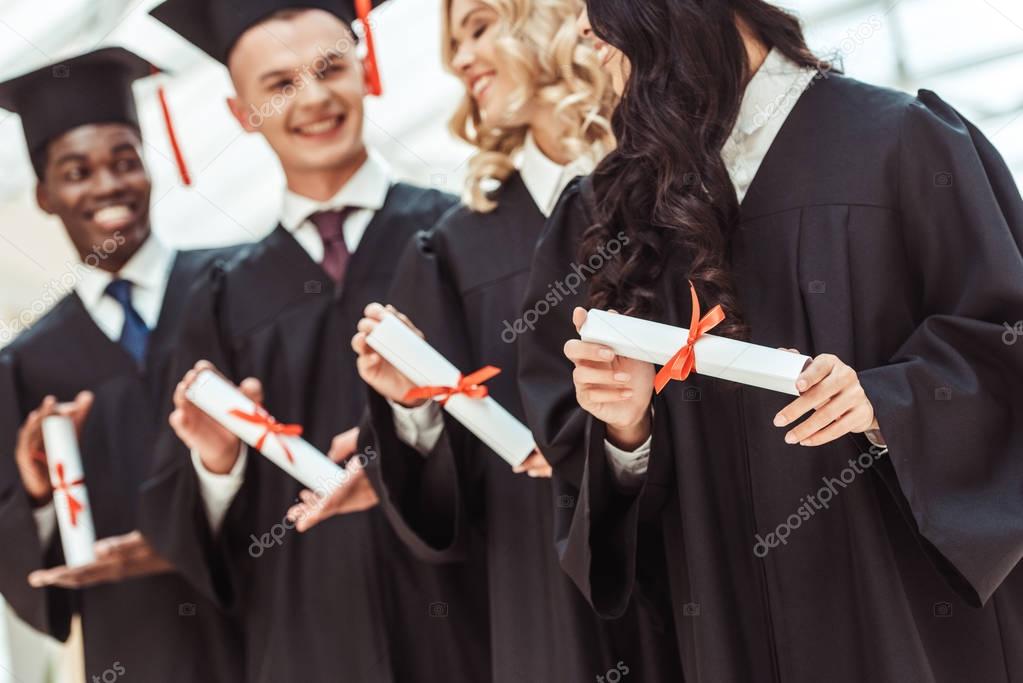 multiethnic students with diplomas