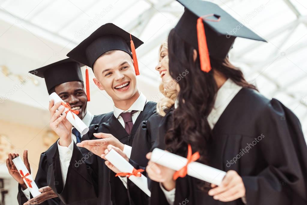 multiethnic students with diplomas