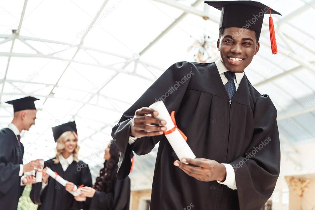 graduated student showing diploma