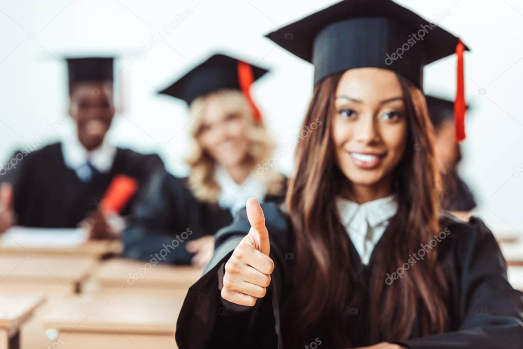 student girl showing thumb up