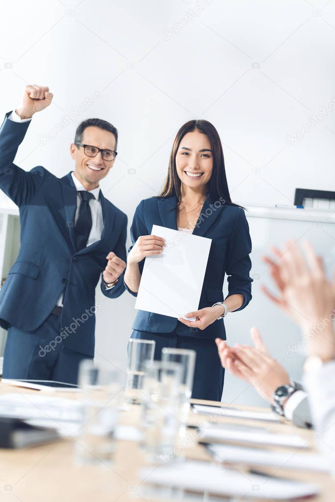 rewarded manageress holding blank paper