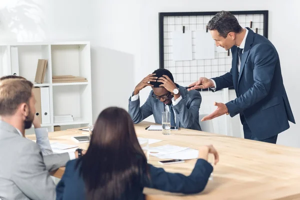 Boss abusing on african american manager — Stock Photo, Image