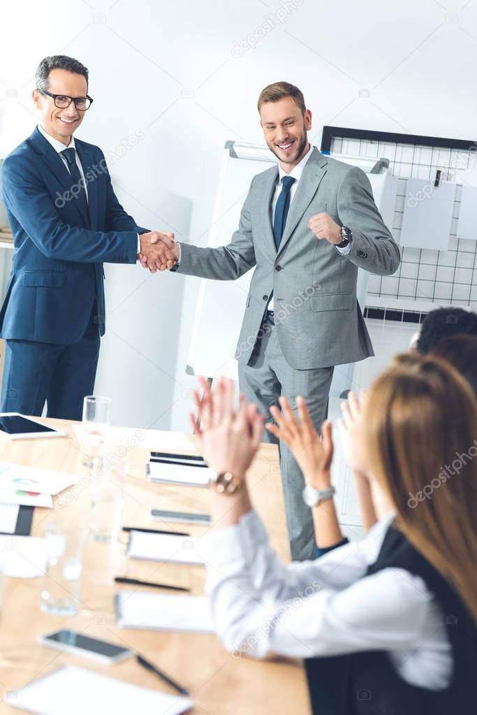 boss shaking hand of manager