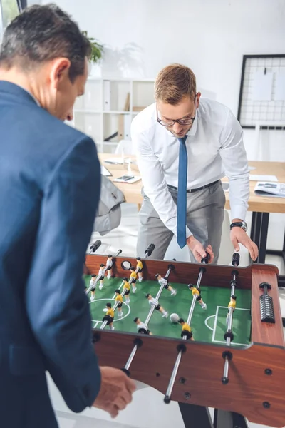 Businessmen playing table football — Free Stock Photo