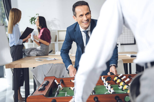 businessmen playing table football