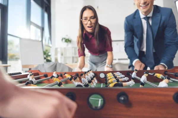 Masa futbolu oynayan iş adamları