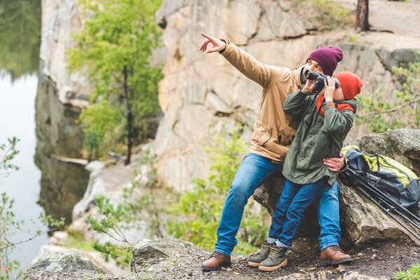 father and son with binoculars