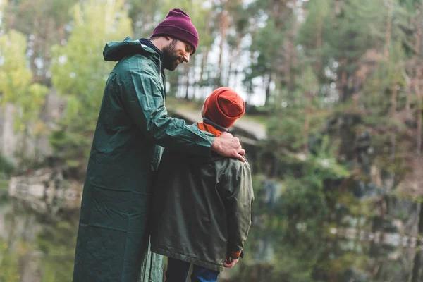 Father and son in autumn forest — Free Stock Photo