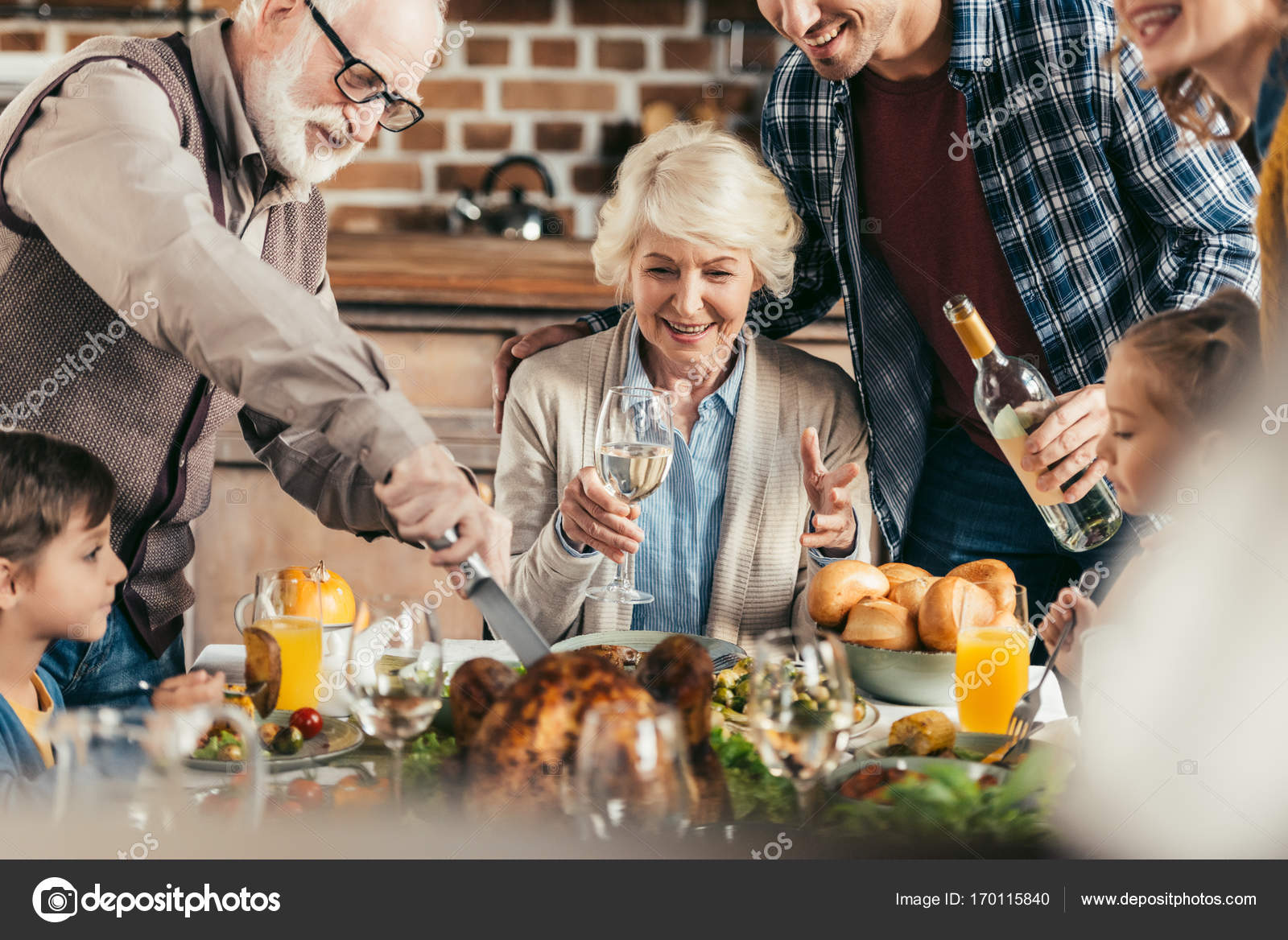 Family having holiday dinner — Stock Photo © ArturVerkhovetskiy #170115840