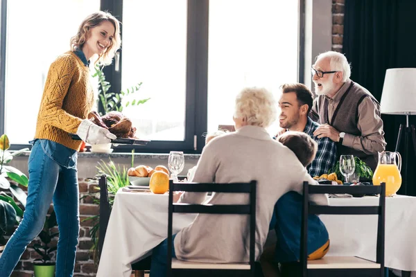 Family looking at thanksgiving turkey — Stock Photo, Image