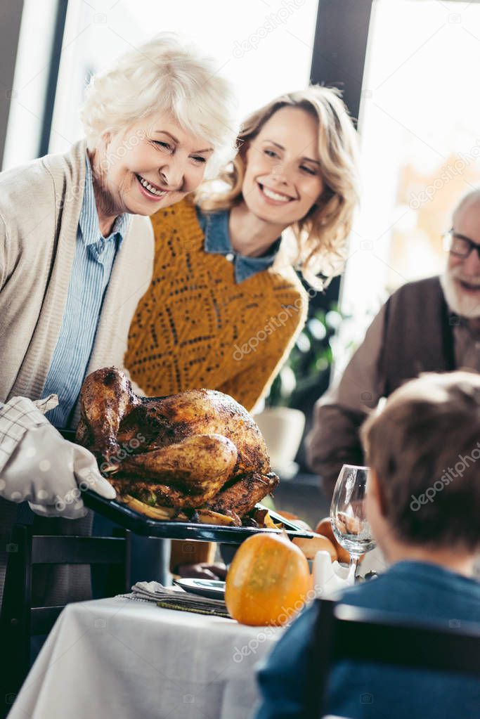 senior mother and daughter with thanksgiving turkey