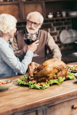 senior couple clinking glasses on thanksgiving clipart