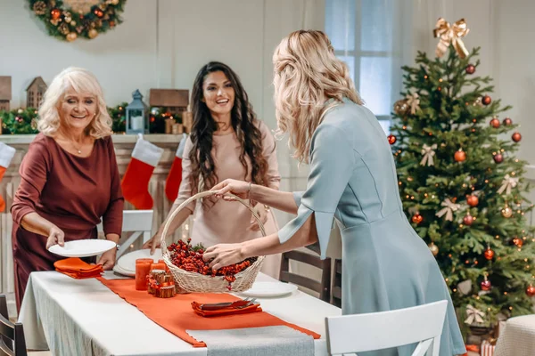 Women decorating christmas table — Stock Photo, Image