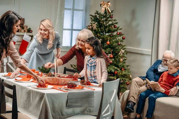 Women decorating christmas table — Stock Photo, Image