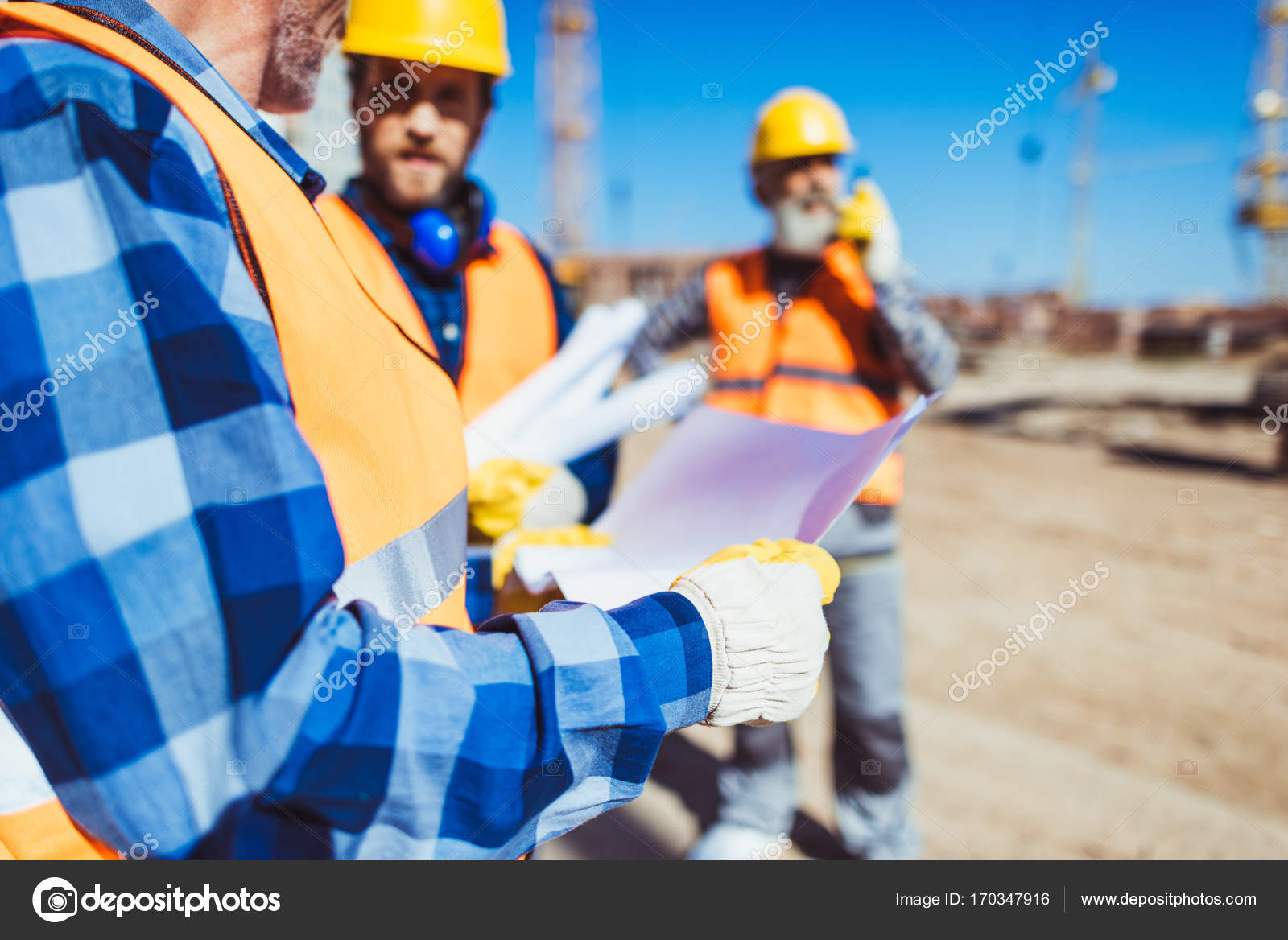 construction-worker-examining-building-plan-stock-photo