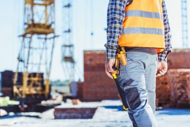 worker in reflective vest at construction site clipart