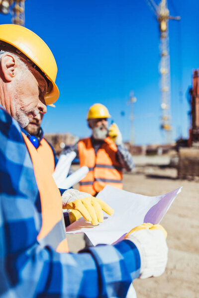 Construction worker examining building plan