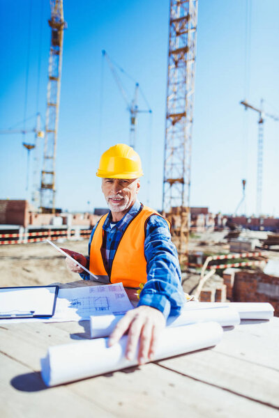construction worker with building plans