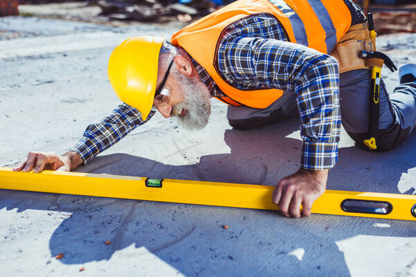 Construction worker using spirit level