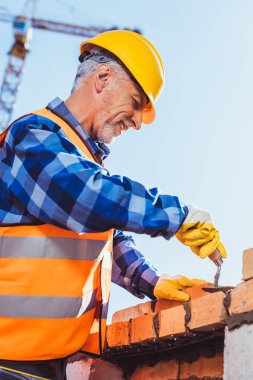 construction worker laying bricks