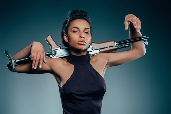 girl posing with rifle