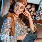 Sorridente ragazza bohemien in occhiali