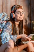 woman in boho style listening to music