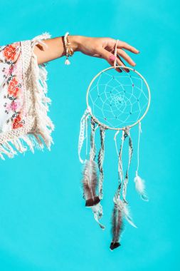 hippie girl holding dreamcatcher in hand clipart