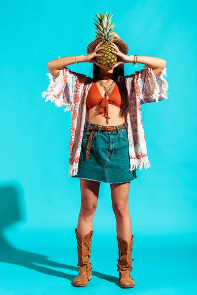 Hippie girl covering face with pineapple — Stock Photo, Image