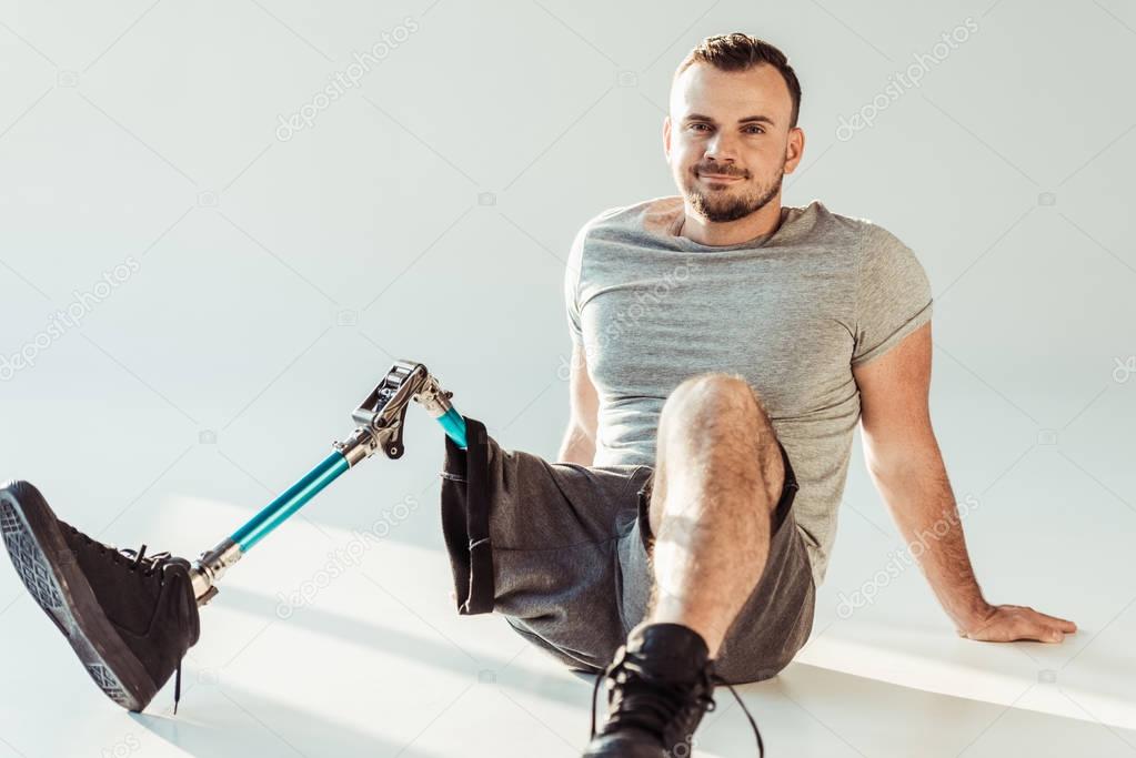 smiling man with leg prosthesis