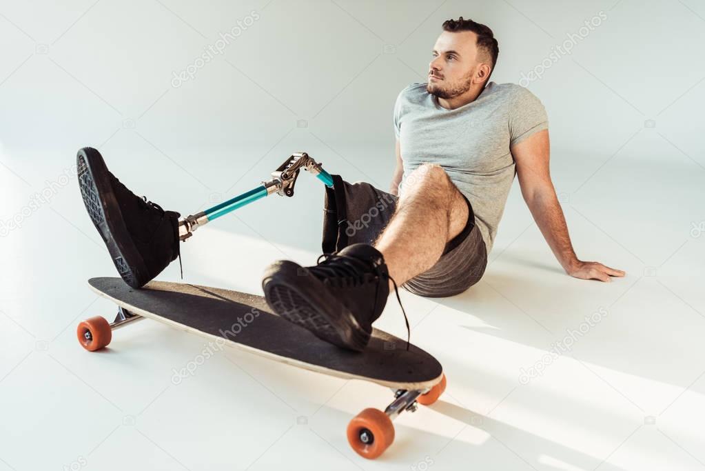 man with leg prosthesis with skateboard