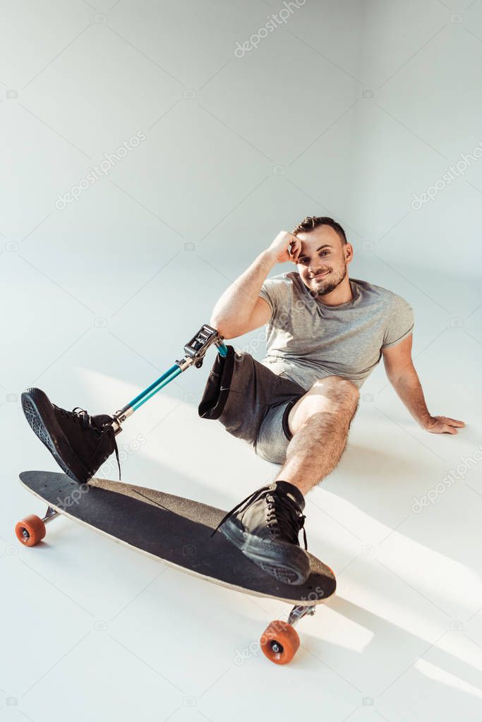 man with leg prosthesis with skateboard